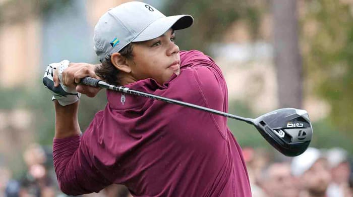 Charlie Woods plays his shot from the first tee during the 2023 PNC Championship at The Ritz-Carlton Golf Club in Orlando, Fla.